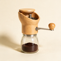 The Grind manual coffee grinder with wood body and hand crank