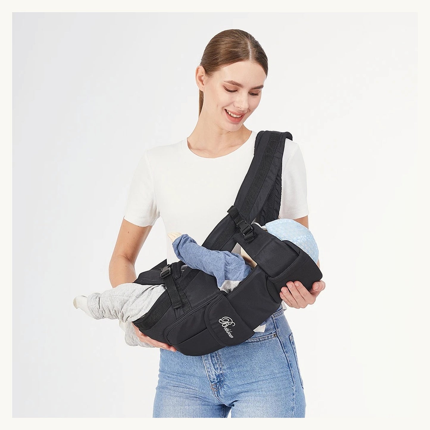 Mother carrying a baby in the CarryCloud carrier cradle position
