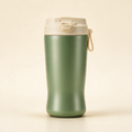 The Commuter insulated travel mug in sage green with cream lid