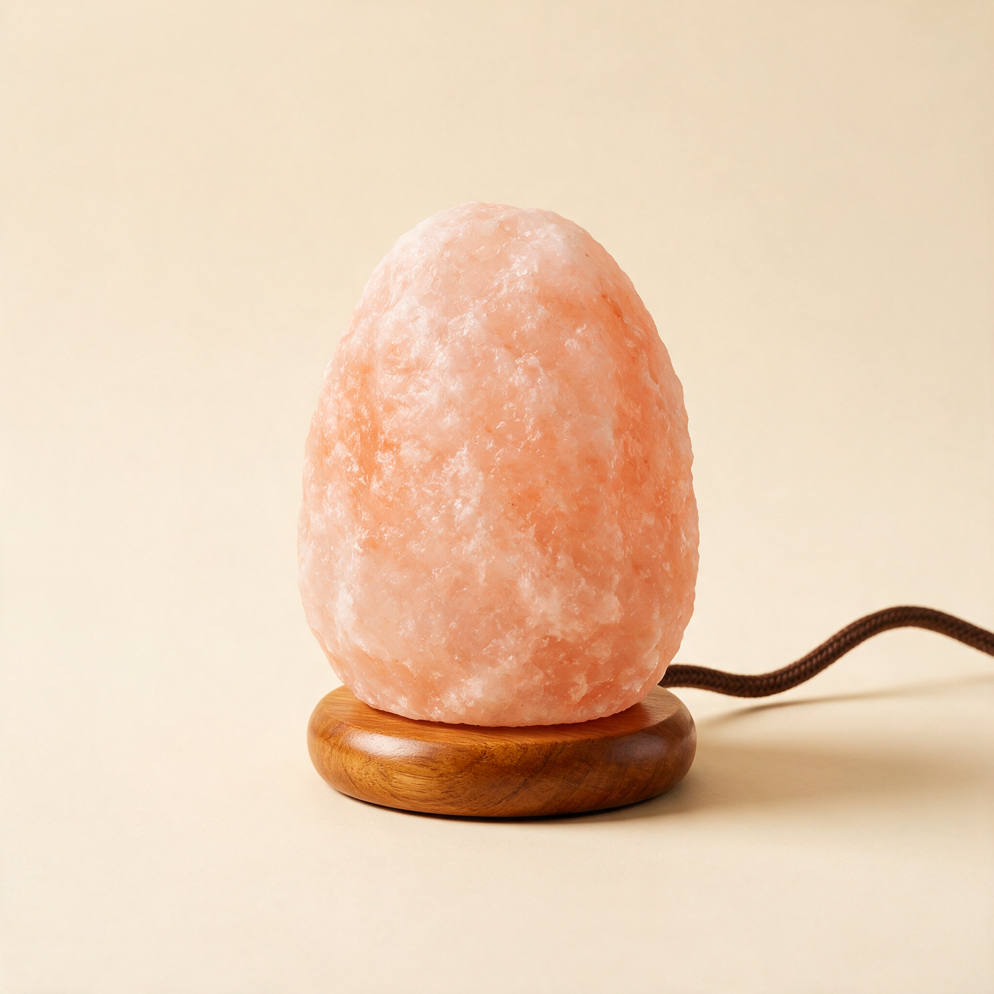 The Glow salt lamp unlit at an angle showing the wooden base