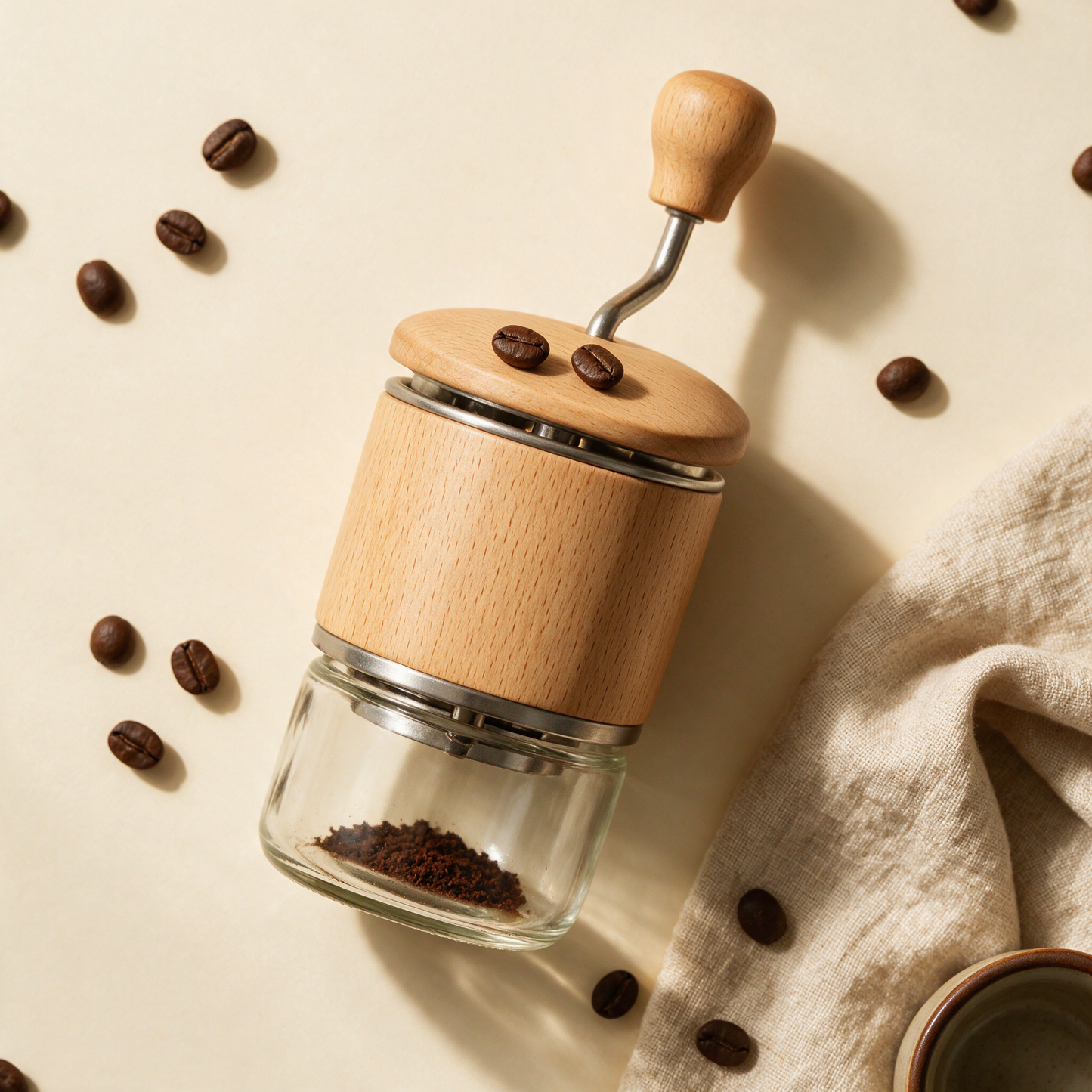 The Grind grinder flat lay with scattered beans and linen