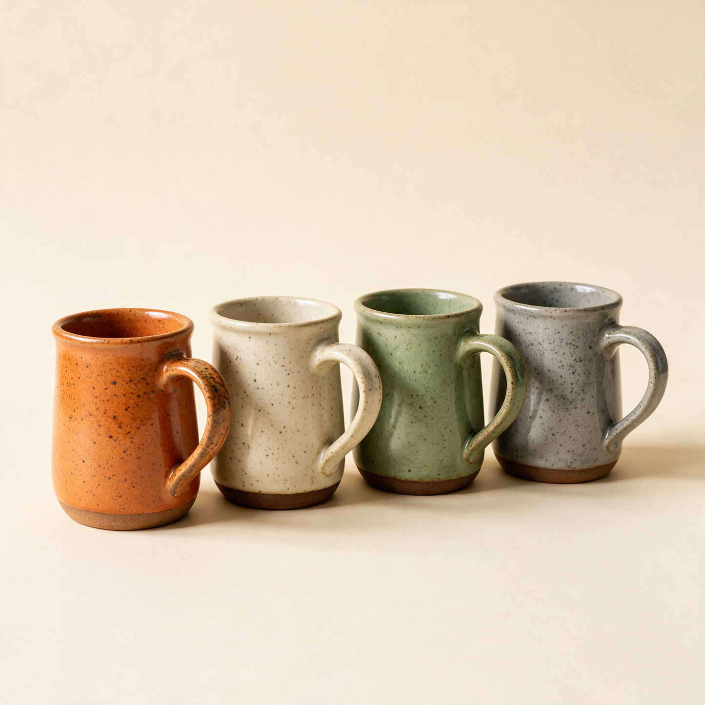 The Daily four stoneware mugs in a row at an angle