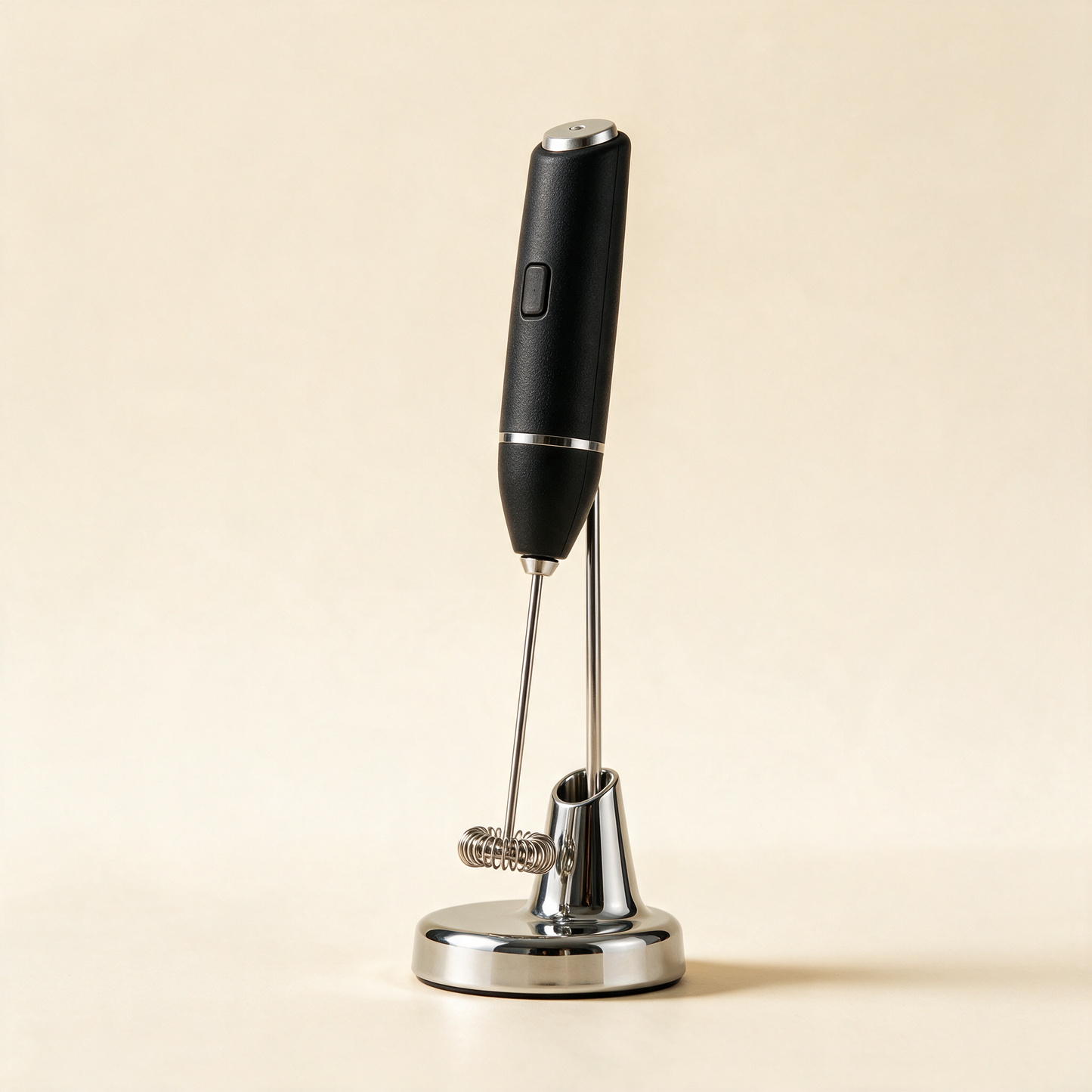 FrothWand milk frother standing on its chrome stand at an angle