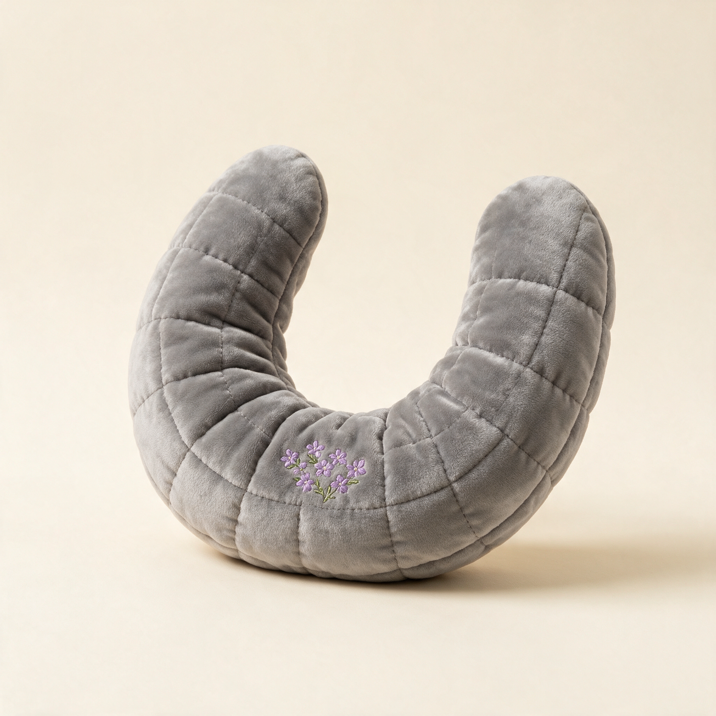 NeckSoothe grey quilted heat wrap at an angle showing the horseshoe shape