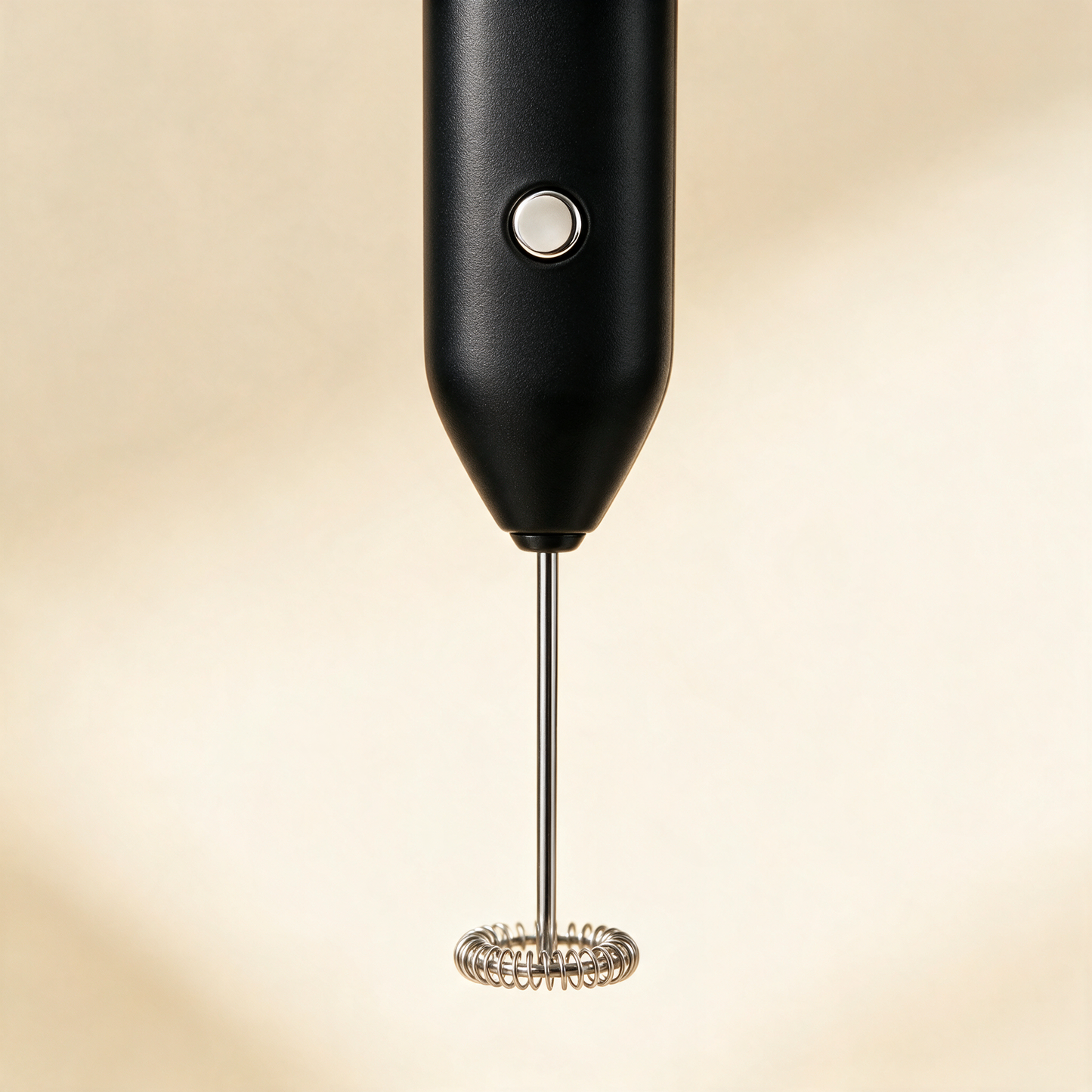 Close-up of the FrothWand black handle, chrome shaft and ring whisk