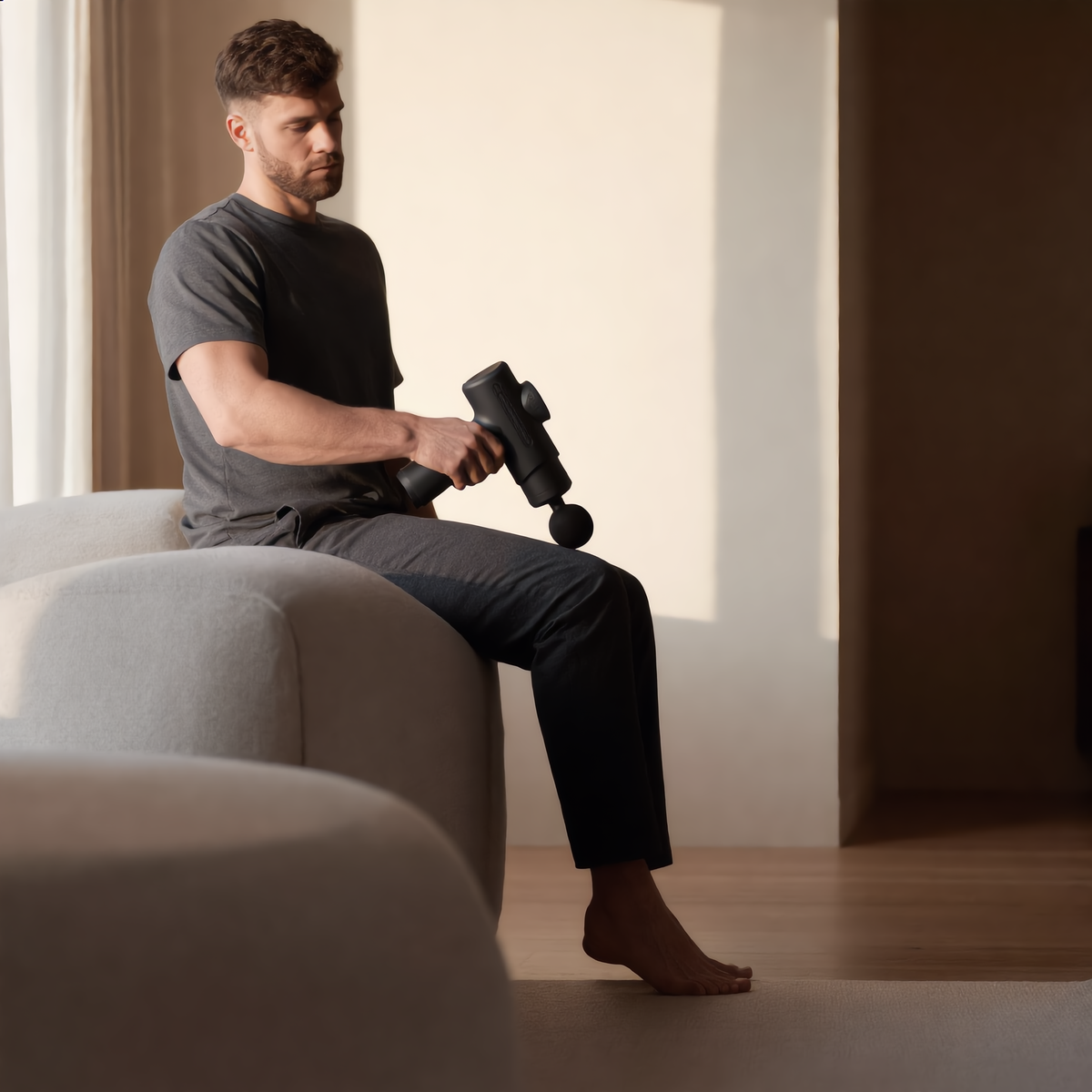 Man using the massage gun on his calf