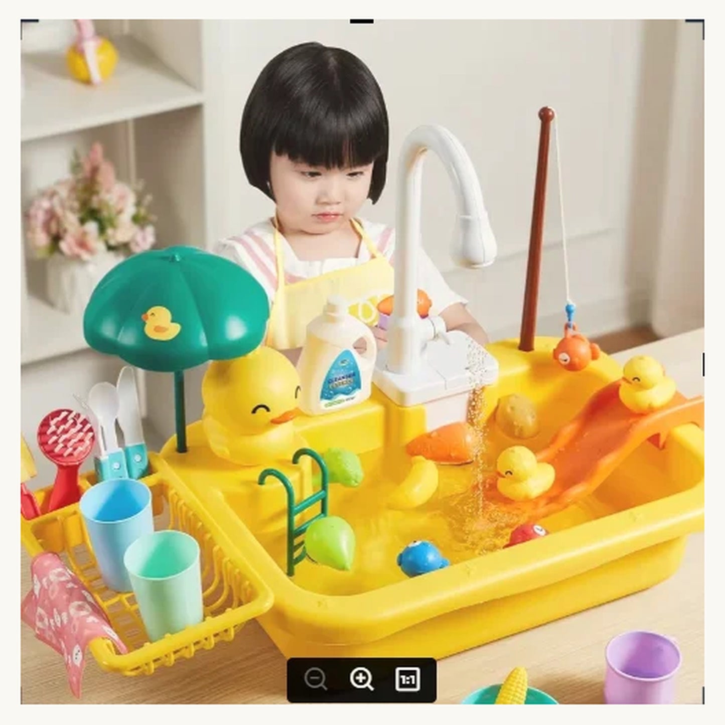 Boy washing toy dishes in the SplashChef play sink