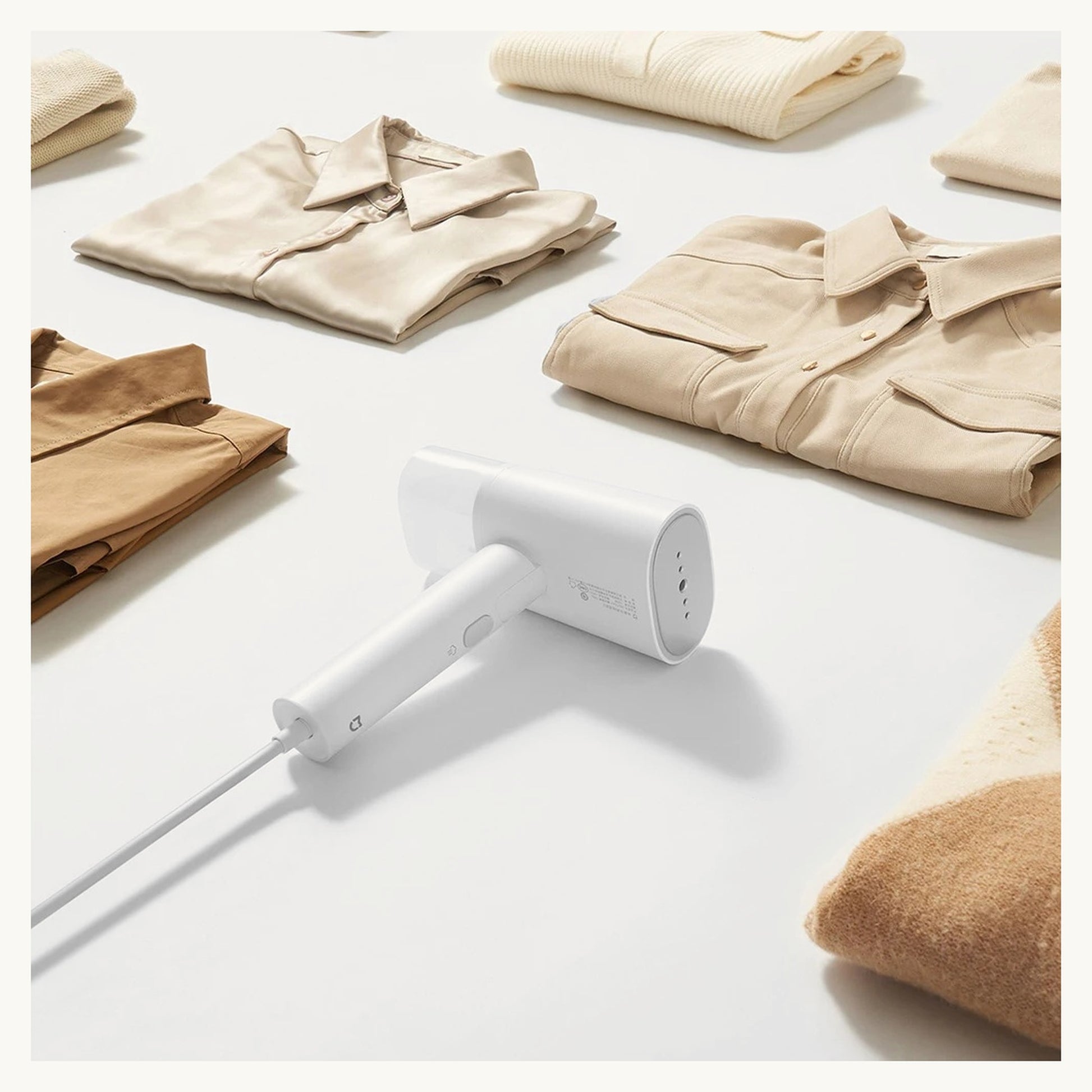 SteamEase steamer with neatly folded clothes